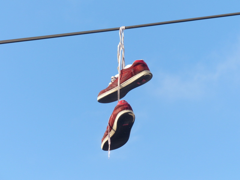 red, black, low angle view, nature, sports shoes, sneakers, metal, cable, shoelaces, hang, hanging, day, shoe, copy space, sign, Leash, rope, sky, blue