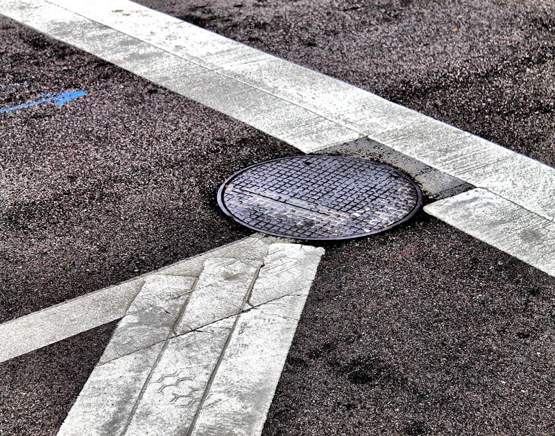 sunlight, black, shoe, sign, no people, urban, manhole, abstract, metal, day, road marking, city, transportation, footpath, road, sewage, dividing line