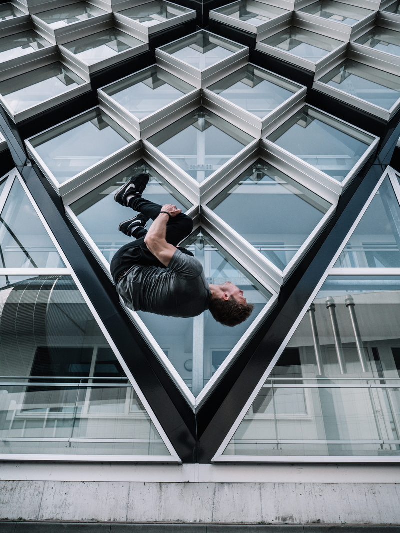 day, aerial view, nike, building, skyscraper, modern architecture, contemporary, backflip, wearing, architectural design, outdoorchallenge, extreme sport