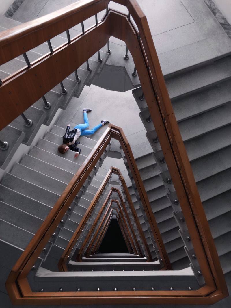 spiral, real people, full length, pants, jacket, 4K, high angle view, building, pattern, staircase, moving up, railing, laying, person, built structure
