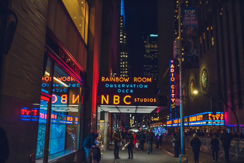 studios, text, real people, architecture, western script, beside, neon, city life, skyscraper, nightlife, crowd, office building exterior, built structure