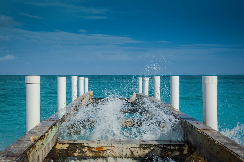 tranquility, splashing, tranquil scene, turks and caicos, outdoors, water, pier, architecture, blue, cloud - sky, sky, bridge, power in nature, waves, beach