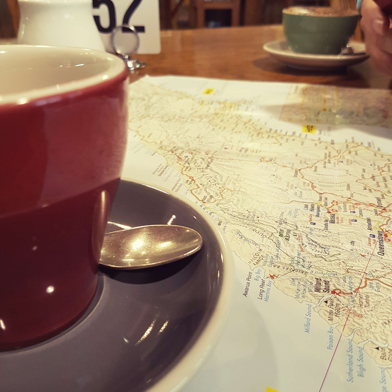 close-up, world map, table, indoors, tea cup, cafeteria, planning, coffee, no people, focus on foreground, direction, paper, travel, food and drink, cup