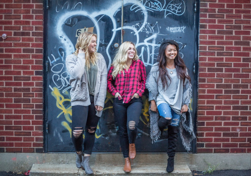 friendship, smiling, casual clothing, full length, plaid, hair, friends, brick, positive emotion, blond hair, wall, girl, girls, women, young women, architecture