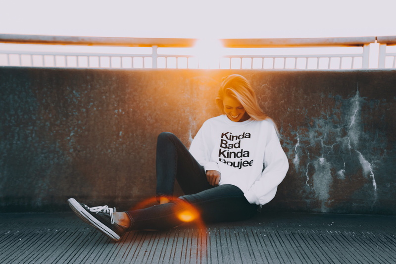 women, text, lifestyles, sits, relaxation, wall - building feature, sunset, long hair, sitting, real people, casual clothing, hair, communication, one person