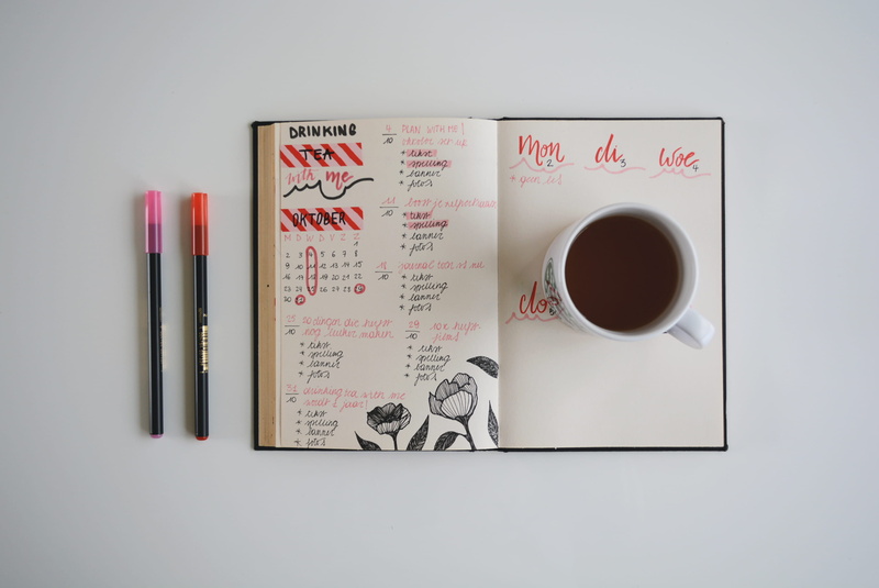 studio shot, coffee, indoors, table, coffee cup, western script, text, no people, stationary, paper, refreshment, journal, food and drink, publication