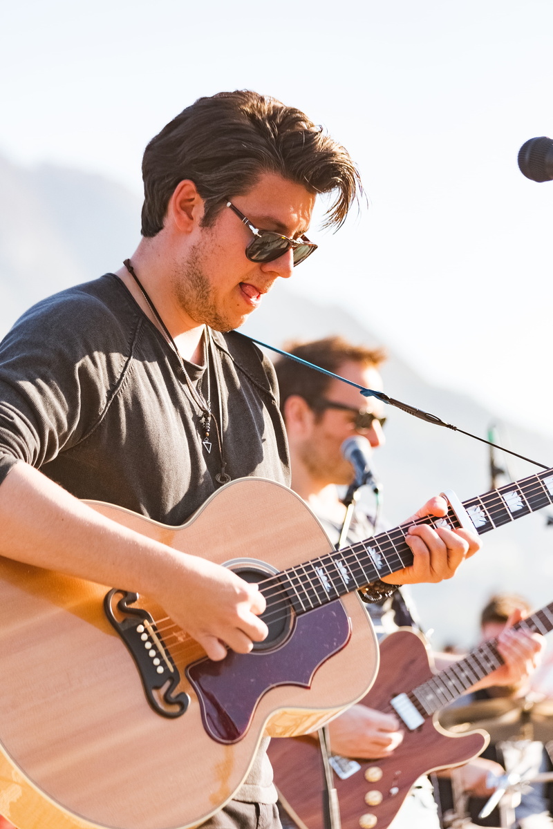 playing, energy, stage, artists, song, performance, stringed instrument, outdoors, male, electric guitar, artist, singer, men, young adult, concert, young men
