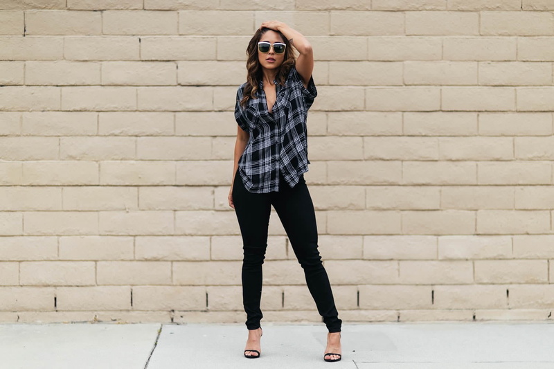 casual clothing, real people, model, wall - building feature, high heels, pants, lifestyles, tattoo, wall, architecture, brick, sunglasses, leisure activity