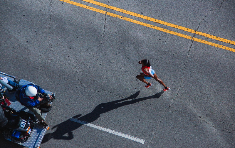 person, symbol, marathon, road marking, runner, men, outdoors, dividing line, real people, transportation, lifestyles, sign, road, full length, shadow