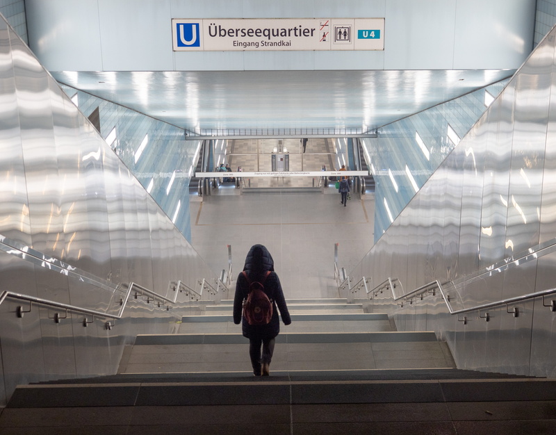 communication, lifestyles, stop, real people, illuminated, full length, platform, rear view, indoors, casual clothing, travel, station, one person, transportation