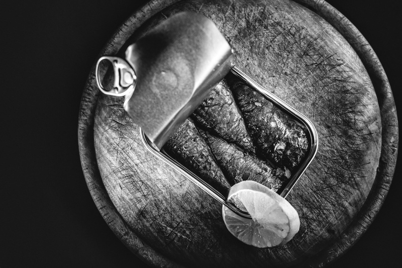 indoors, fish, freshness, spoon, still life, human body part, black background, box, table, fruit, metal, eat, directly above, lunch, kitchen utensil, lemon