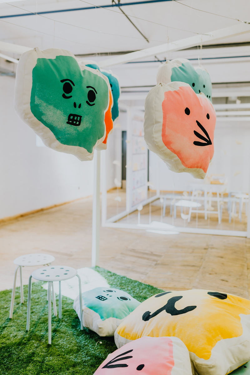 pillows, male likeness, faces, close-up, 5K, still life, focus on foreground, face, anthropomorphic smiley face, no people, representation, art and craft