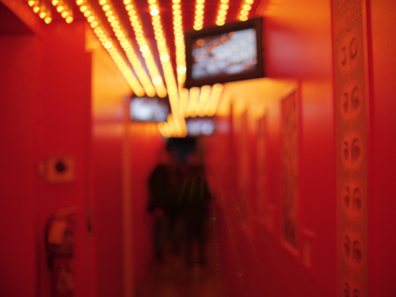 interior design, focus on foreground, selective focus, monitor, spotlight, electronics, purple, tv, display, office, text, close-up, red, entrance, arcade game machine