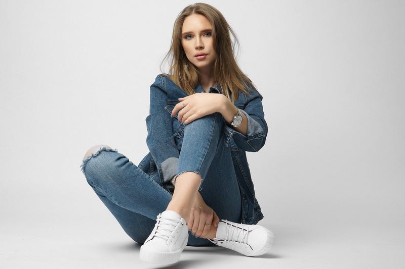 brunette, simple background, jean jacket, jeans, Nikolay Khvatov, model, women, sneakers, 1080P, sitting