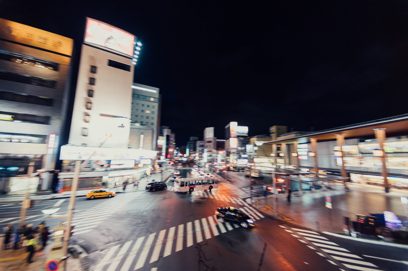 human, sky, night, car, mode of transportation, travelling, downtown, city life, town, built structure, person, road, metropolis, building, city, traffic