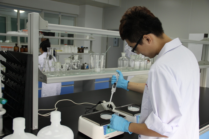 women, people, lab coat, standing, holding, figure, device, molecular biology, hairstyle, white, experiment, one woman only, only women, clothing, laboratory