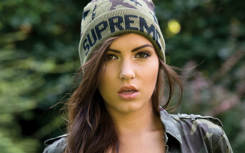 headshot, focus on foreground, young adult, clothing, lifestyles, outdoors, hair, front view, hairstyle, contemplation, model, day, cap, brunette, long hair