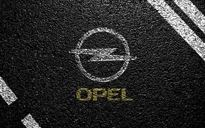 road marking, textured, representation, directly above, communication, Vauxhall, high angle view, street, day, logo, sign, city, road, Opel, symbol, transportation