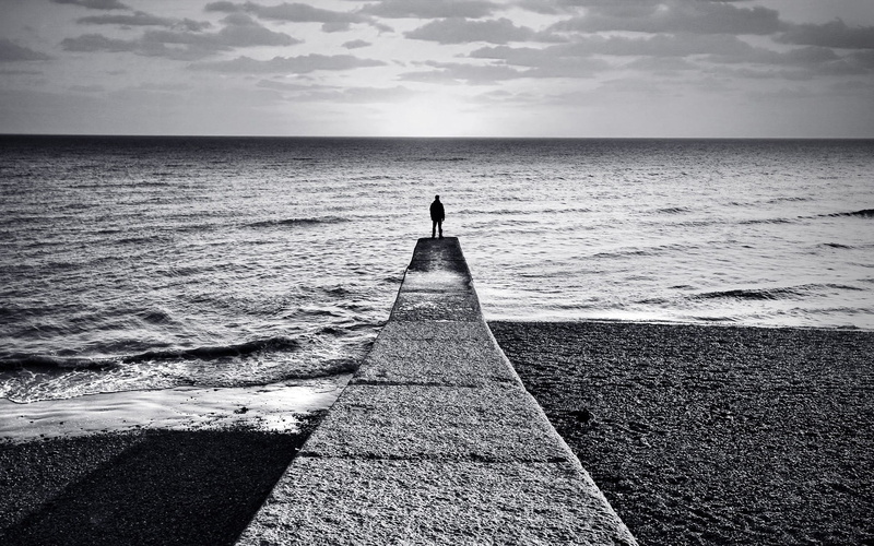 scenics - nature, beach, land, tranquility, sea, the way forward, beauty in nature, leisure activity, water, alone, standing, monochrome, tranquil scene