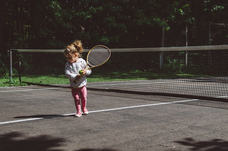 beside, toddler, brown, court, arms raised, women, day, playing, ball, shadow, lines, lawn, pitch, girls, daytime, child, tennis, girl, white, white line
