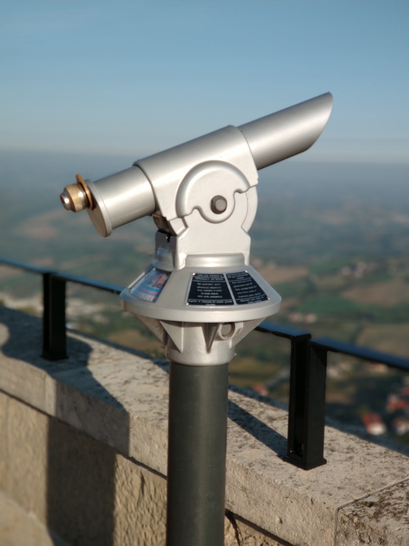 coin operated, sky, outdoors, sunlight, metal, binoculars, optical instrument, security, surveillance, astronomy, height, nature, silver colored, no people