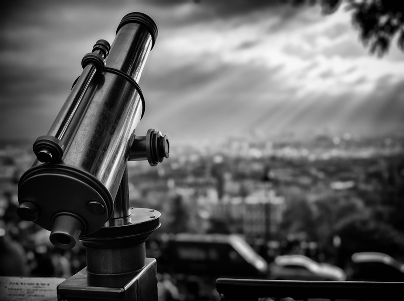 grayscale, day, hand-held telescope, Stars, focus on foreground, optical instrument, binoculars, coin operated, outdoors, astronomy, close-up, metal, cityscape