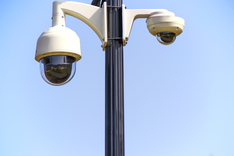 electric lamp, street light, lighting equipment, industry, video registration, external cameras, no people, copy space, day, sky, outdoors, low angle view