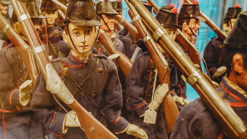 people, architecture, costume, day, helmet, human representation, government, boot, clothing, focus on foreground, legion, crowd, the past, weapon, musical instrument