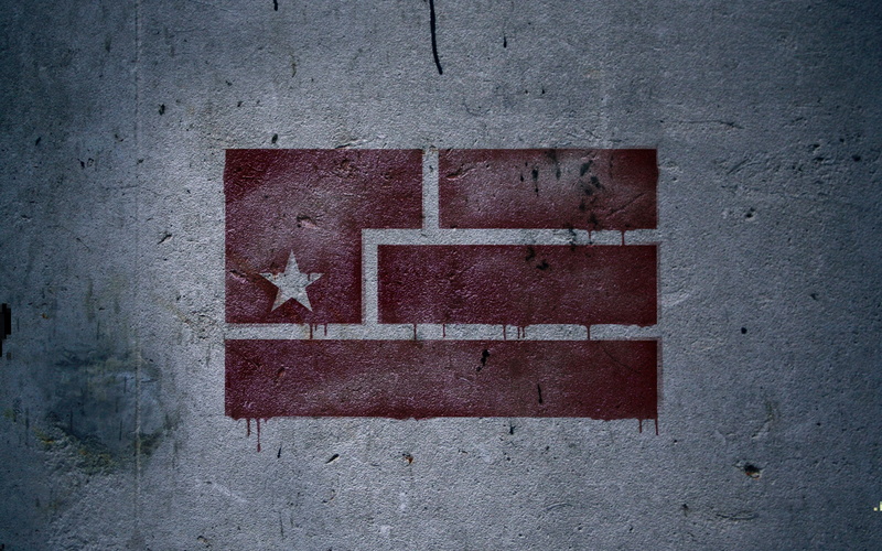 Nine Inch Nails, text, white color, arrow symbol, day, built structure, wall - building feature, brick wall, sign, close-up, symbol, red, outdoors, concrete
