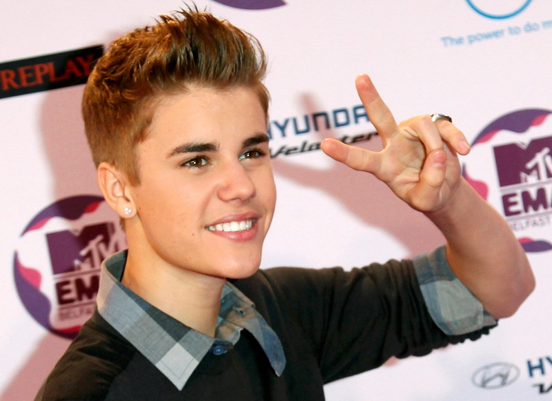 holding, teenager, close-up, cheerful, smiling, men, emotion, portrait, headshot, happiness, indoors, toothy smile, justin bieber   and screensavers, one person