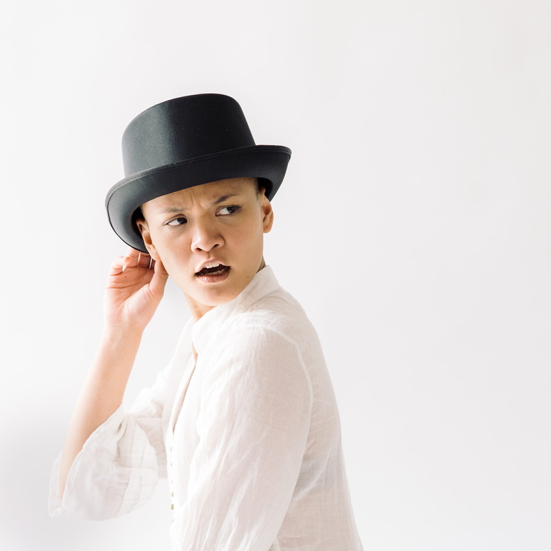 white background, beautiful woman, mouth, model, 2K, portrait, hat, side, copy space, looking at camera, looking, adult, high-key, style, holding, left