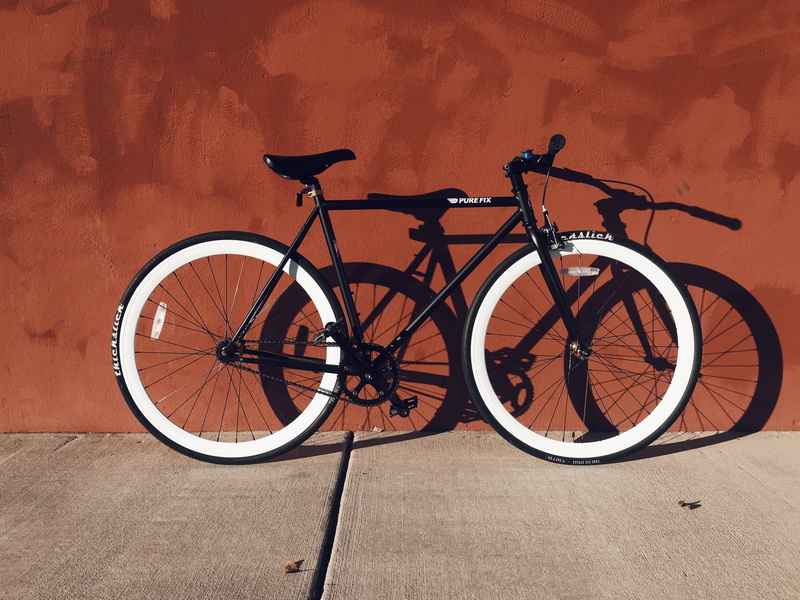 brown, wall, orange, rigid, paint, built structure, parking, day, black, orange color, near, transportation, stationary, nature, land vehicle, footpath