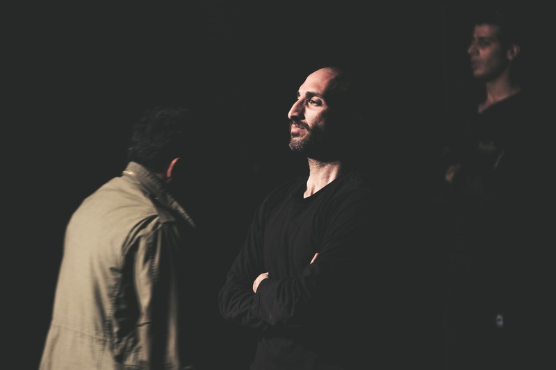 set up, waist up, standing, clothing, facial hair, cross, man, studio shot, apparel, look, dark, portrait, black background, theater, beard, men, girl