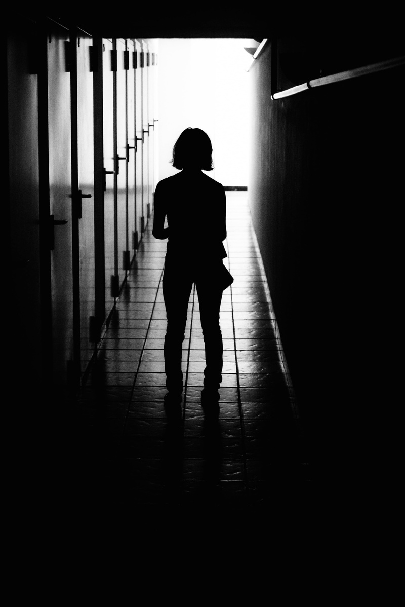 lifestyles, shadow, depression - sadness, direction, corridor, woman, light, adult, wall, rear view, one person, indoors, real people, floor, women, photo