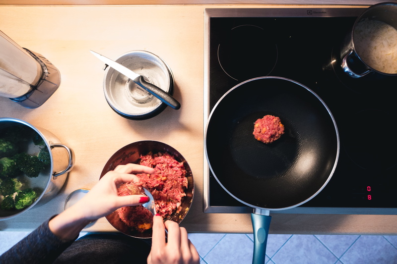 frying pan, hand, cooking Pan, holding, human body part, only women, ground, food and drink, people, adults only, personal perspective, kitchenware, meat