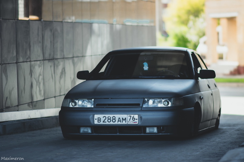 building exterior, small, motor Vehicle, toy, focus on foreground, black, urban Scene, modern, text, number, auto, engine, road, car, shiny, machine, Lada