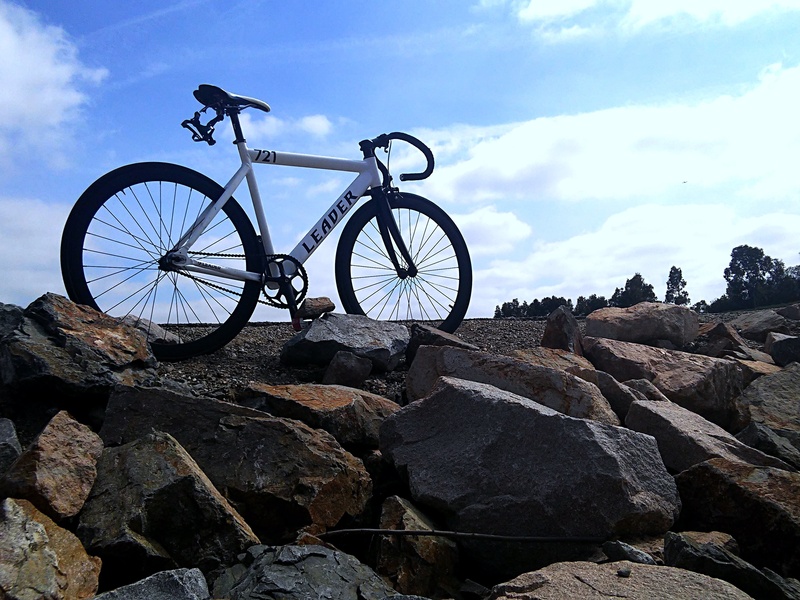 low angle view, lifestyle, blue, bike, leisure, silhouette, stones, sport, life, pebble, mode of transportation, cycle, healthy, cloud, biking, speed, way