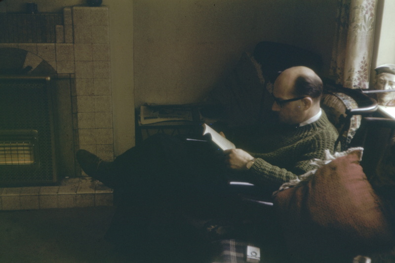 publication, home interior, human, communication, analog, head, adult, pets, screen, lifestyles, one person, 35mm, book, one animal, sitting, glasses, indoors