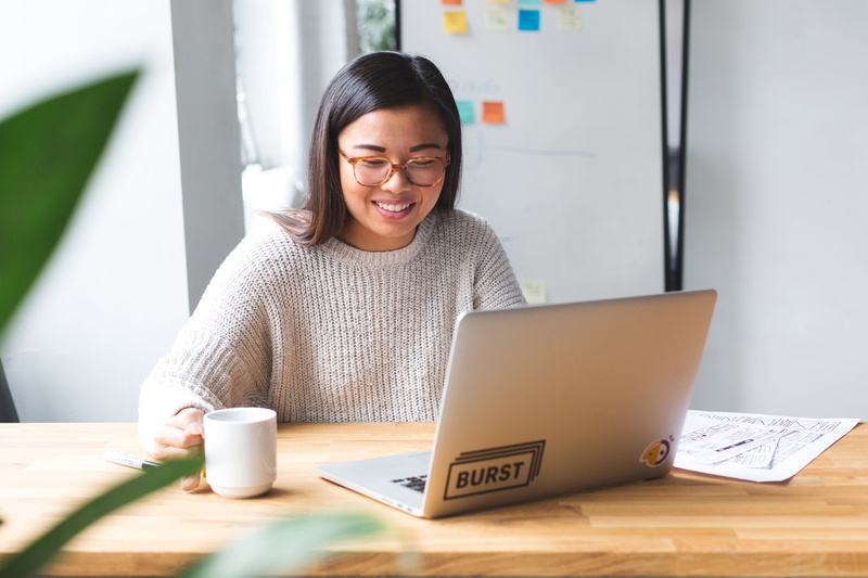 using laptop, adult, table, wireless technology, hairstyle, Computer, web, 4K, mug, young adult, sitting, Design, Graphic Designer, day, smiling, starting