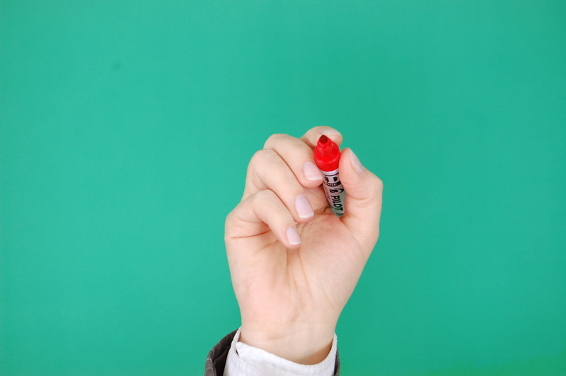 business, red, holding, turquoise colored, writing, green background, close-up, finger, human limb, presentation, indoors, write, human hand, body part