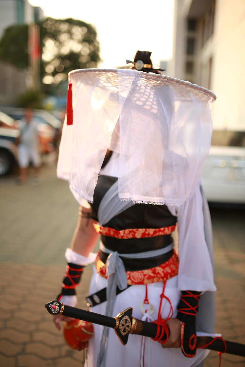 weapon, day, holding, attack, street, clothing, japanese, focus on foreground, sword, one person, unrecognizable person, ninja, cosplay, samurai, men, real people