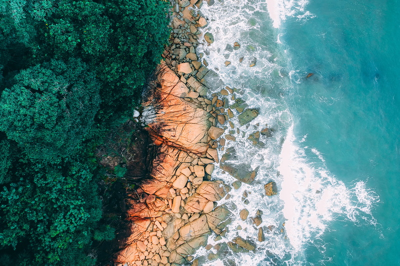blue, rock - object, rock, wave, color, turquoise, seashore, aerial, environment, outdoors, birds eye view, water, trees, no people, aquatic, rocks, photography