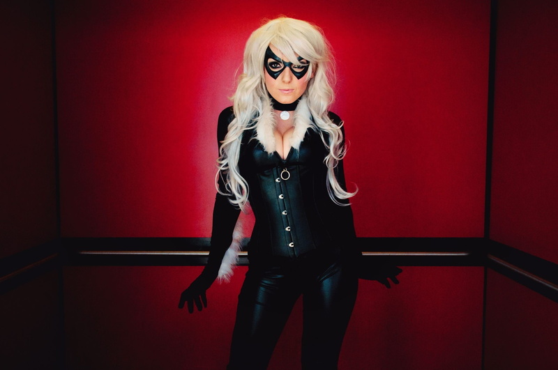 hairstyle, blond hair, cleavage, adult, red, front view, young adult, eyeglasses, beautiful woman, three quarter length, Jessica Nigri, Black Cat (character)