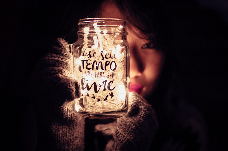 western script, hand, christmas lights, glow, focus, luminescence, headshot, teenager, blur, females, evening, human hand, indoors, one person, obscured face