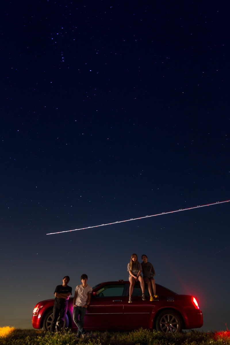star - space, car, outdoors, nature, standing, long exposure, night, sky, people, plane, positive emotion, friends, leisure activity, stars, mode of transportation