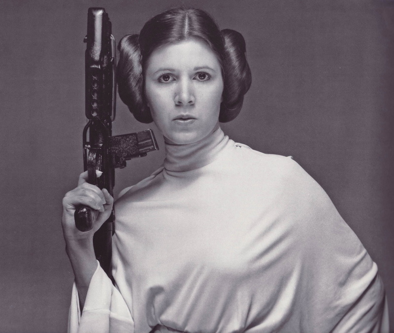 looking at camera, hairstyle, holding, beauty, Carrie Fisher, Star Wars, young women, headshot, indoors, young adult, front view, waist up, aggression