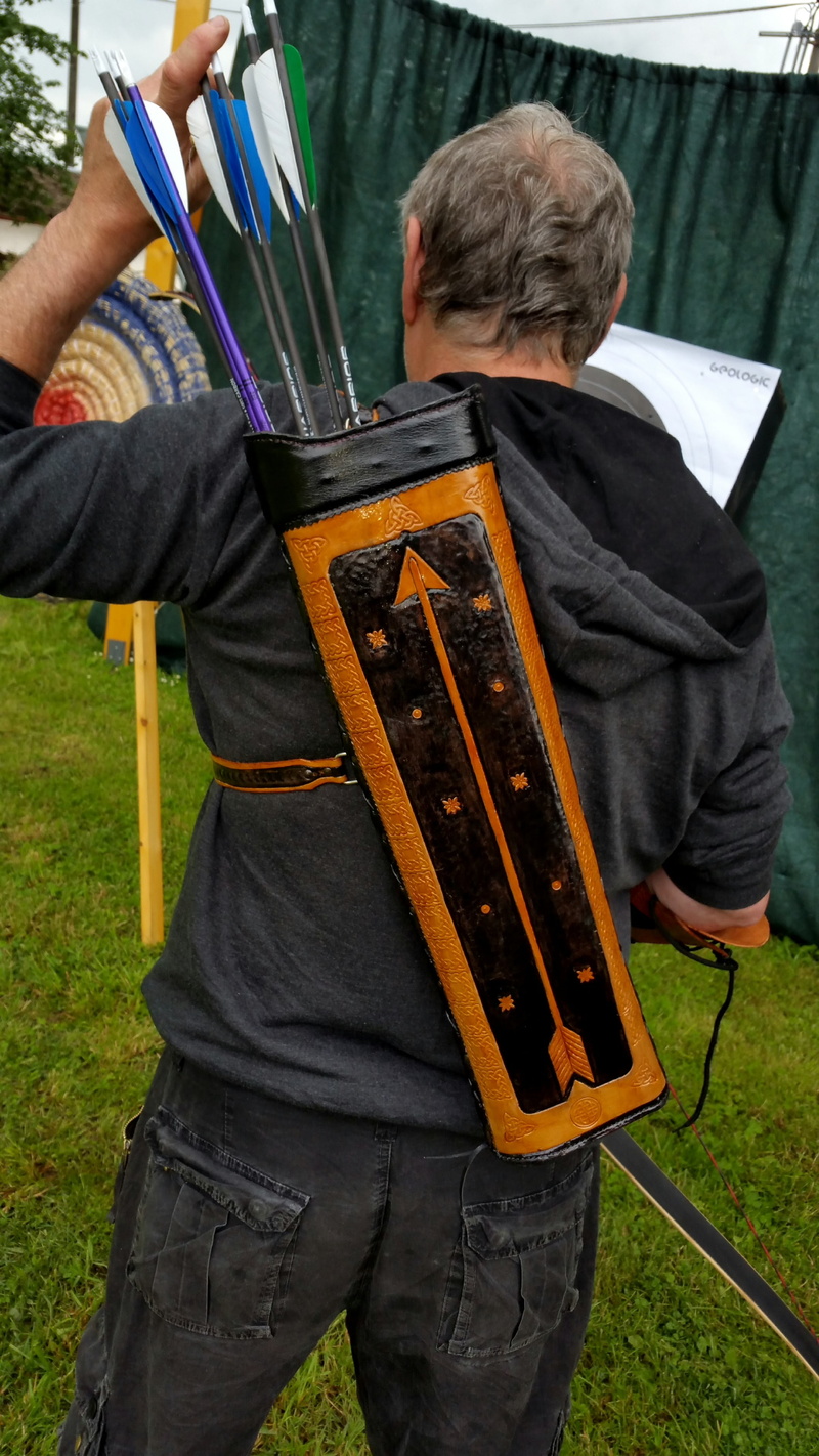 2K, front view, handmade, real people, three quarter length, senior Adult, lifestyles, people, casual clothing, darts, standing, day, quiver, leather accessories