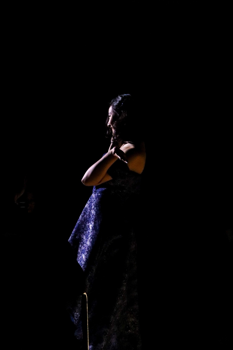 blue, warning sign, woman, performer, human, dress, performance, 4K, black background, stage, real people, apparel, person, leisure activities, wearing