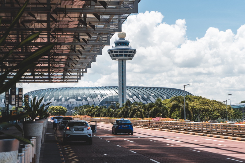 nature, built structure, road, tree, land vehicle, no people, changi, tower, car, city, structures, transportation, human, terminal, building, automobile