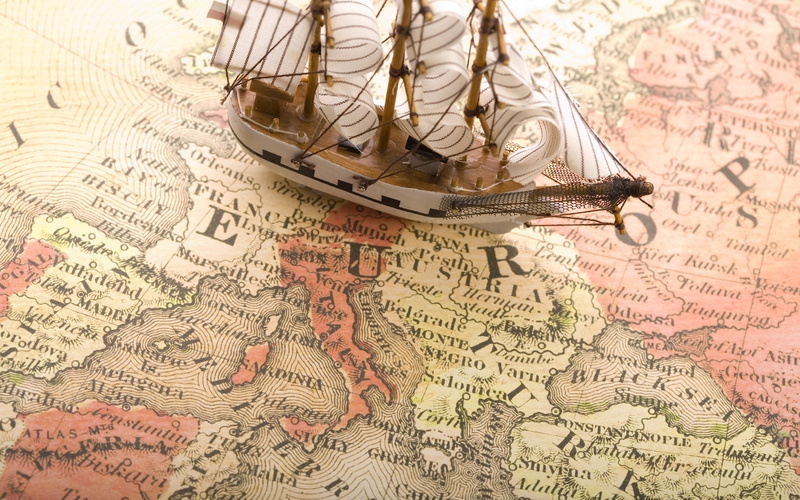 studio shot, digital art, communication, text, travel, close-up, antique, business, indoors, architecture, world map, sailing ship, paper, no people, finance
